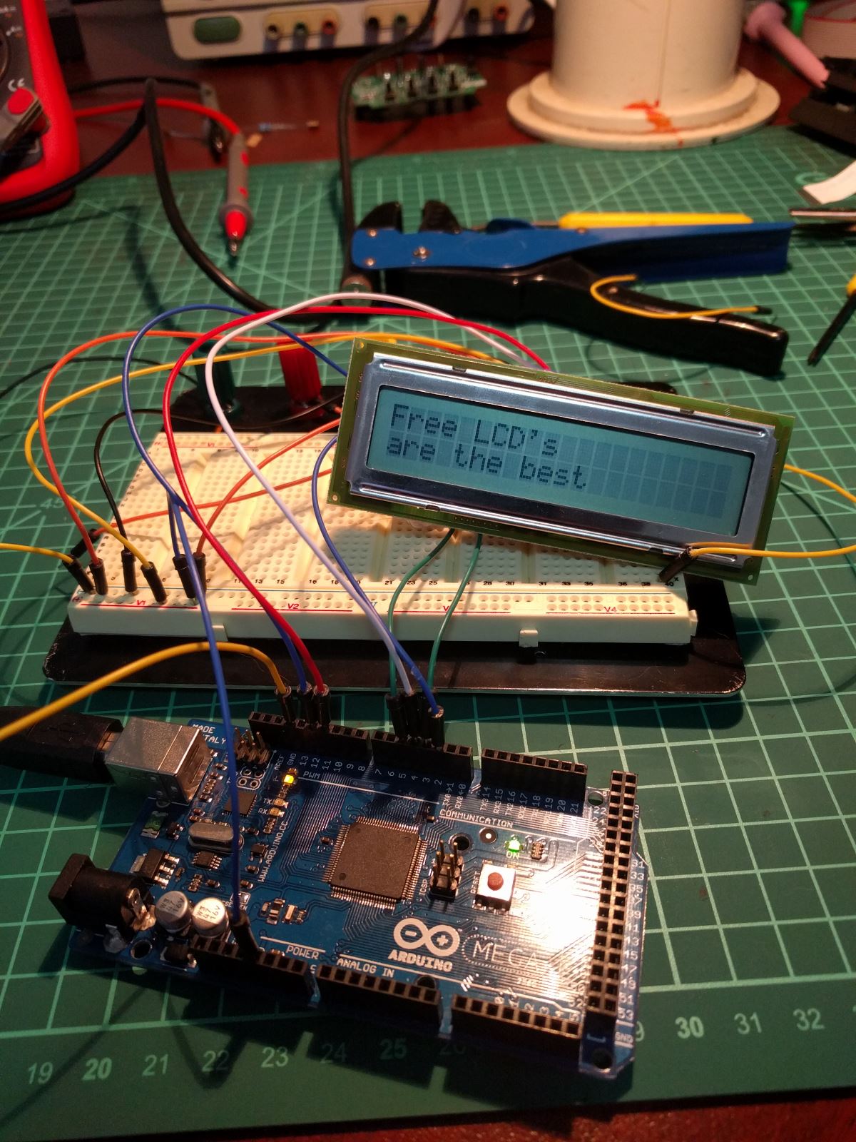 A working LCD wired to a breadboard displaying characters